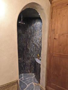 a bathroom with a shower with a stone wall at Beautiful apartment over the mountain in Crans-Montana