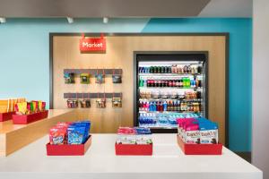 a store with a counter with a drink refrigerator at avid hotels - Prattville - Montgomery North, an IHG Hotel in Prattville