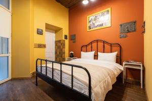 um quarto com uma cama com paredes cor de laranja em Post House Rooms em Lviv