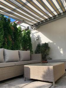 a patio with a couch and a table on a patio at Amadeus Apartment in Baden