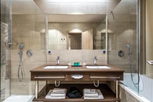 a bathroom with two sinks and a shower at Hotel Plaža Duće in Duće