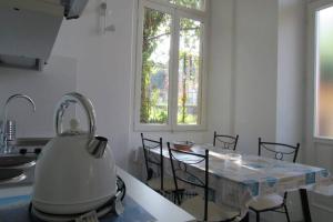 a kitchen with a table with a tea kettle on it at Villa Peachey, Intero piano con giardino in Stresa