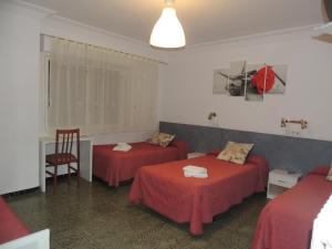 Una cama o camas en una habitación de Hostal Cumbre