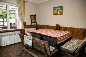 a room with a bed and two chairs and a window at Dniprovskiy Dvir in Dnipro