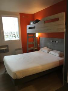 A bed or beds in a room at ibis budget Rochefort