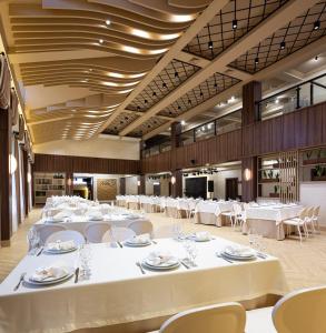 a large banquet hall with white tables and chairs at NeboS Hotel & Restaurant in Ivano-Frankivsʼk