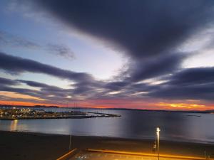 a view of a harbor with a cloudy sky at Apartamentos Ferrán Paqui in Roses