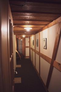 a hallway in a building with wooden ceilings at Pension Sonne in Adelboden