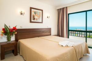 a bedroom with a bed with a view of the ocean at Cerro Mar Atlantico & Cerro Mar Garden in Albufeira