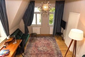 uma sala de estar com um sofá verde e uma janela em Apartmenthaus am Dom "Maisonette" em Zwickau