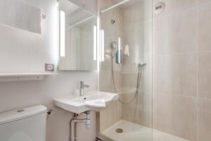 a bathroom with a sink and a shower at B&B HOTEL Louveciennes in Louveciennes