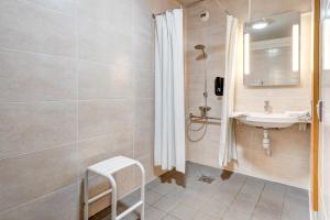 a bathroom with a sink and a shower at B&B HOTEL Louveciennes in Louveciennes