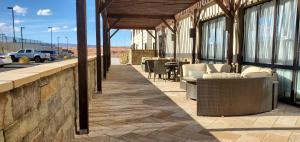 un patio avec des chaises et des tables dans un bâtiment dans l'établissement Wingate by Wyndham Page Lake Powell, à Page