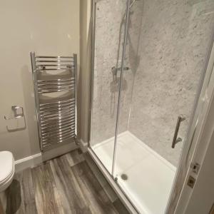 a bathroom with a shower and a toilet at The Inn At Charlestown in Dunfermline