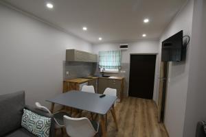 a small kitchen with a table and chairs in a room at Auto-Camping Park in Jelenia Góra