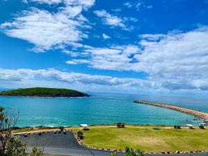 an island in the middle of a body of water at Surf Beach Motel Coffs in Coffs Harbour