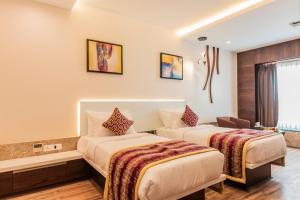 Una cama o camas en una habitación de Hotel Park Elanza Coimbatore