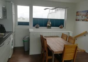 a kitchen with a wooden table and chairs in a kitchen at Schwimmendes Ferienhaus Swimming Lounge in Kappeln