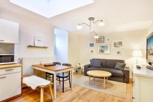 a living room with a couch and a table at Apartmenthaus Tribseer Damm 6 in Stralsund