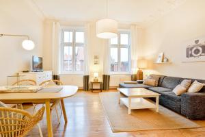 a living room with a couch and a table at Apartmenthaus Tribseer Damm 6 in Stralsund