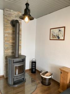 a living room with a wood stove in a room at Villa Ammonit in Pottenstein