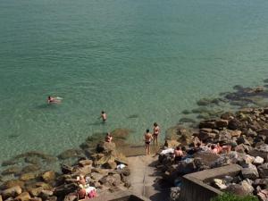 a group of people in the water at a beach at Appartement cosy les pieds dans l’eau, vue mer exceptionnelle in Crozon