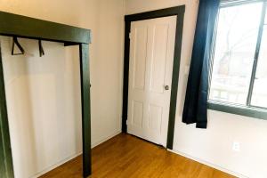 an empty room with a door and a window at Garden of the Gods RV Resort in Colorado Springs