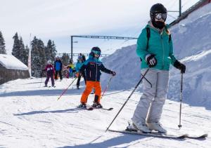 eine Gruppe von Personen, die auf einer schneebedeckten Piste Ski fahren in der Unterkunft Maison de Montagne de Bretaye accès par le train arrêt Bouquetin in Villars-sur-Ollon