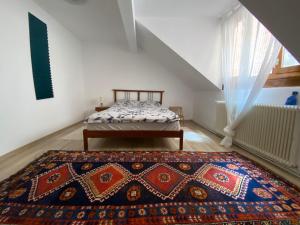 um quarto com uma cama e um tapete no chão em Rebreanu Suite em Sibiu