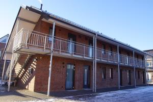 a red brick building with two balconies on it at Hotel zur Erholung in Buxtehude