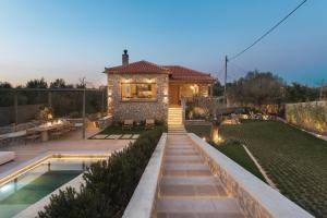 a house with a garden with a swimming pool at OD Luxury Villa in Pylos