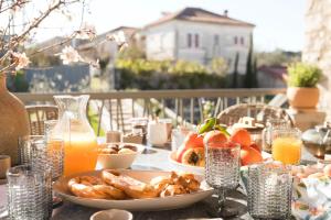 a table with a plate of food and drinks on it at OD Luxury Villa in Pylos