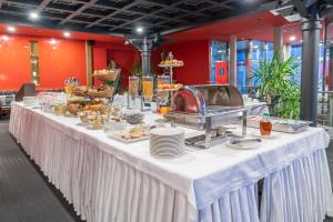 a long white table with food on it at Hotel Europe in Davos