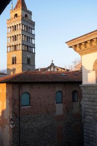 a building with a clock tower in the background at Residenza Roma in Pistoia