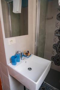 a bathroom with a white sink and a shower at Residenza Roma in Pistoia