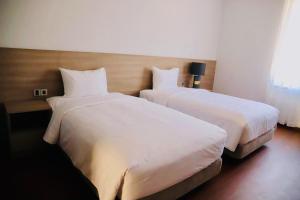 เตียงในห้องที่ Mansion Park Hotel & Apartment