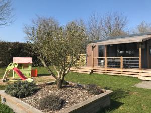 ein winziges Haus mit Rutsche und Spielplatz in der Unterkunft Cottage du garlai in Bressuire