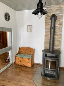 a fireplace in a living room with a stove at Villa Ammonit in Pottenstein