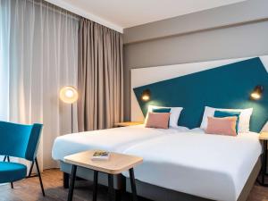 Säng eller sängar i ett rum på Aparthotel Adagio Lille Centre Grand Place