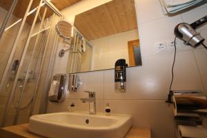 a bathroom with a sink and a shower at Haus Alpenglühn in Längenfeld