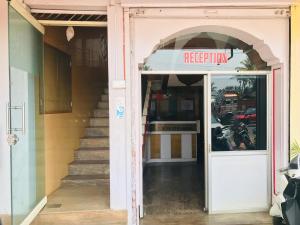 an entrance to a restaurant with a sign over the door at Ice Berg Deluxe Lodge in Kushālnagar