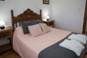 a bedroom with a large bed with pillows on it at Apartamentos Alegría in Santillana del Mar