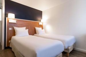 Katil atau katil-katil dalam bilik di Comfort Hotel ORLY-RUNGIS