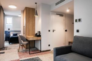 a living room with a couch and a desk at Hotel Vesper House in Gdańsk