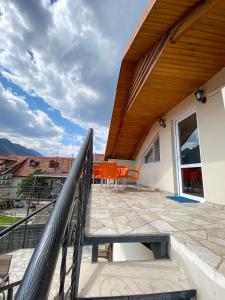 a patio with a wooden roof and a railing at Guest House IBERIA in Mtskheta