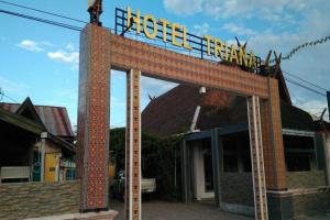 a sign for a hotel in front of a building at OYO 2527 Hotel Triana in Palangkaraya