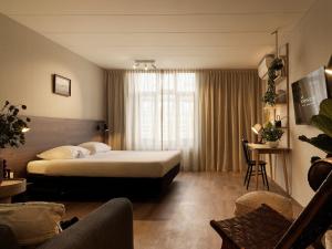 Tempat tidur dalam kamar di Townhouse Apartments Maastricht