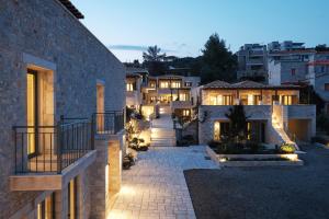 a courtyard of a house with lights on it at Margo Beach Hotel in Gythio