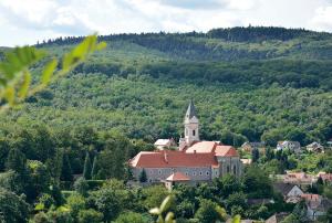 uma igreja no meio de um vale com árvores em Vadászkürt Panzió em Sopron