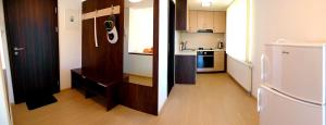 two pictures of a kitchen with a refrigerator and a kitchen with at Apartmány Dalila in Rajecké Teplice